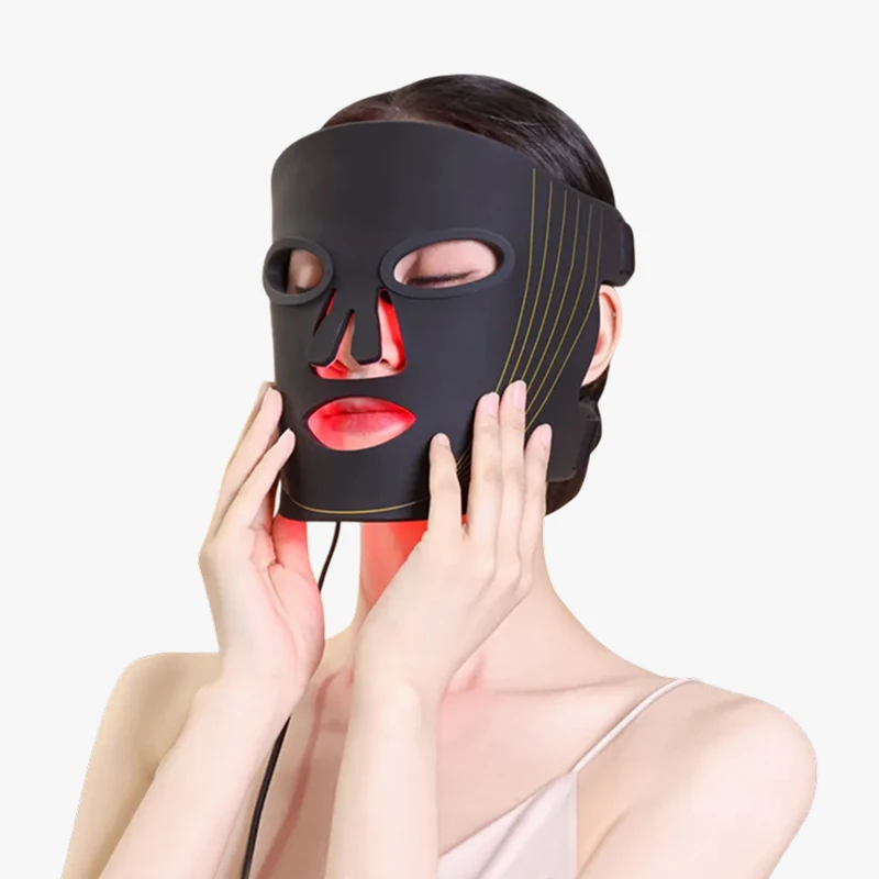 Mujer con la máscara Auren puesta y la luz roja encendida, con una mano junto al rostro.